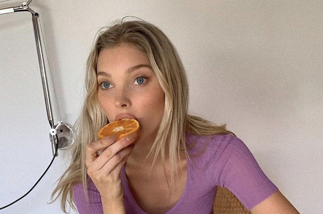 Ženska s pomarančo v roki.