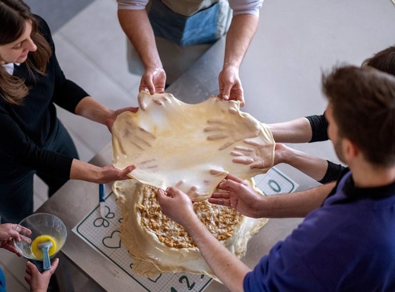 Doživeli smo teambuilding, ki ga ne pozabiš: spekli smo odlično prekmursko gibanico (po tradiciji in hkrati trajnostno!)